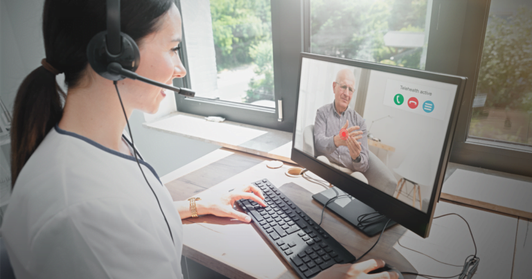 Female healthcare worker providing telehealth appointment to elderly man