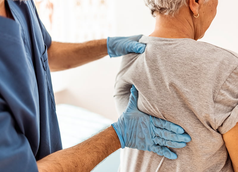 Chiropractor treating muscle knots in a chiropractic office