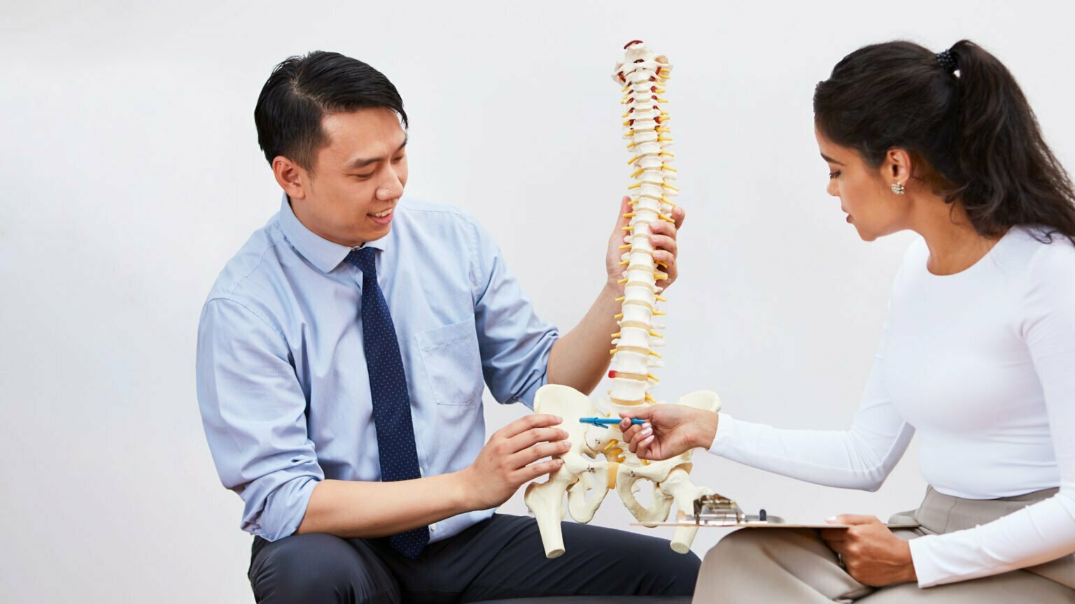 Contact Us Canadian Chiropractic Association CCA   Chiropractors Looking At A Spine Model 1536x864 