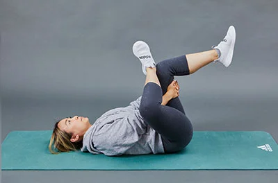 A woman performing a hip stretch