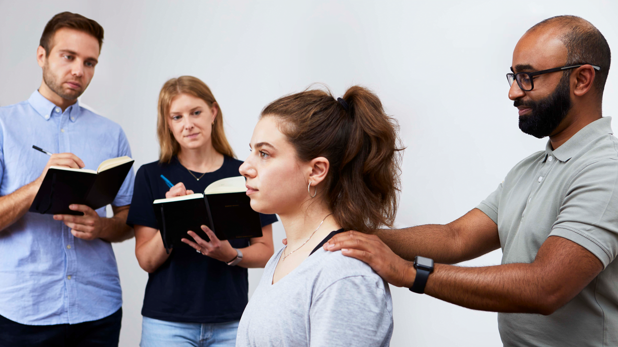 chiropractor with patient and students