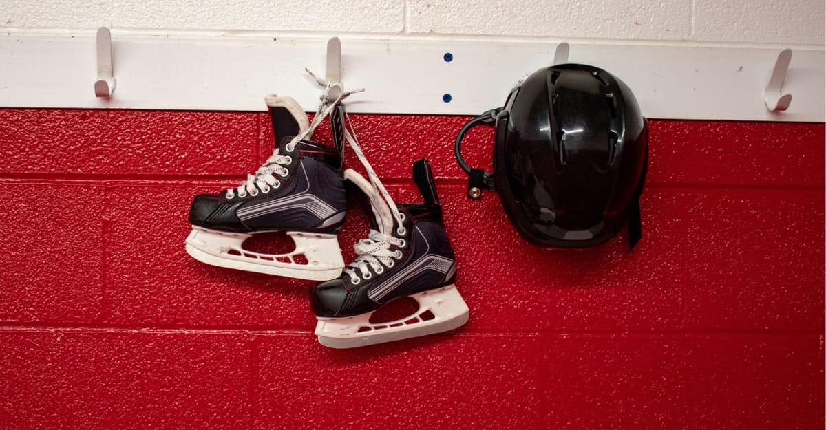 Hockey skates and a helmet hanging in a locker room. (Photo: MCRMfotos / iStock)