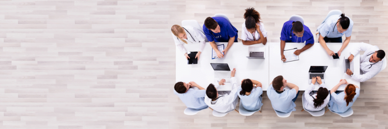 Healthcare Professionals on a meeting table discussing as a team