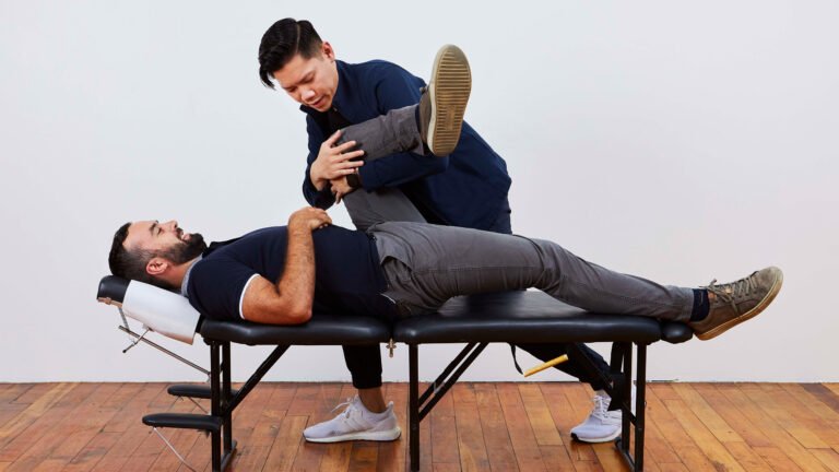 male chiropractor treating a patient