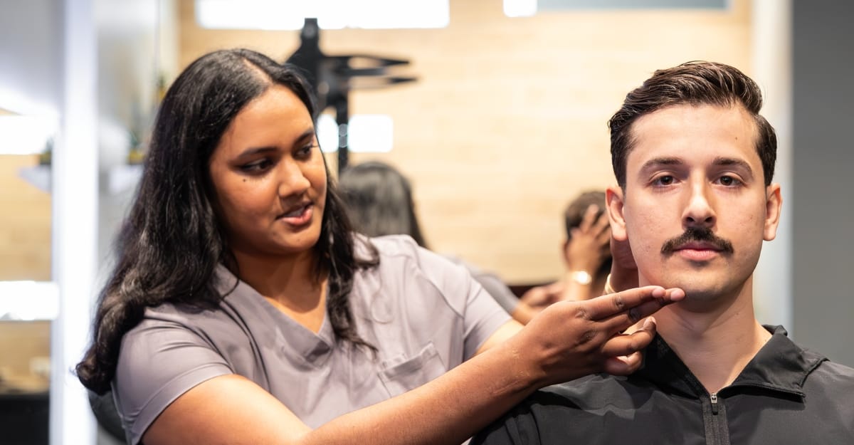 A chiropractor assesses a patient at a gym.